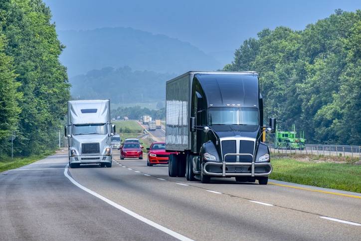 Horizontal shot of mixed traffic on a rural section of a Tennessee interstate highway.